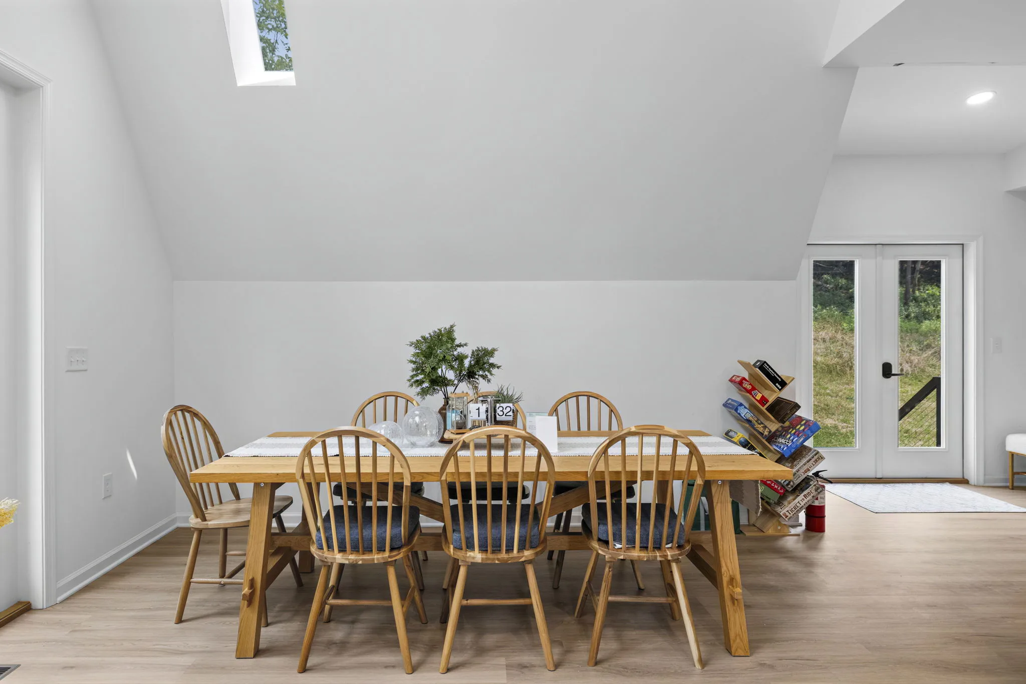 Wood dining table with seating for six beneath the A-frame ceiling