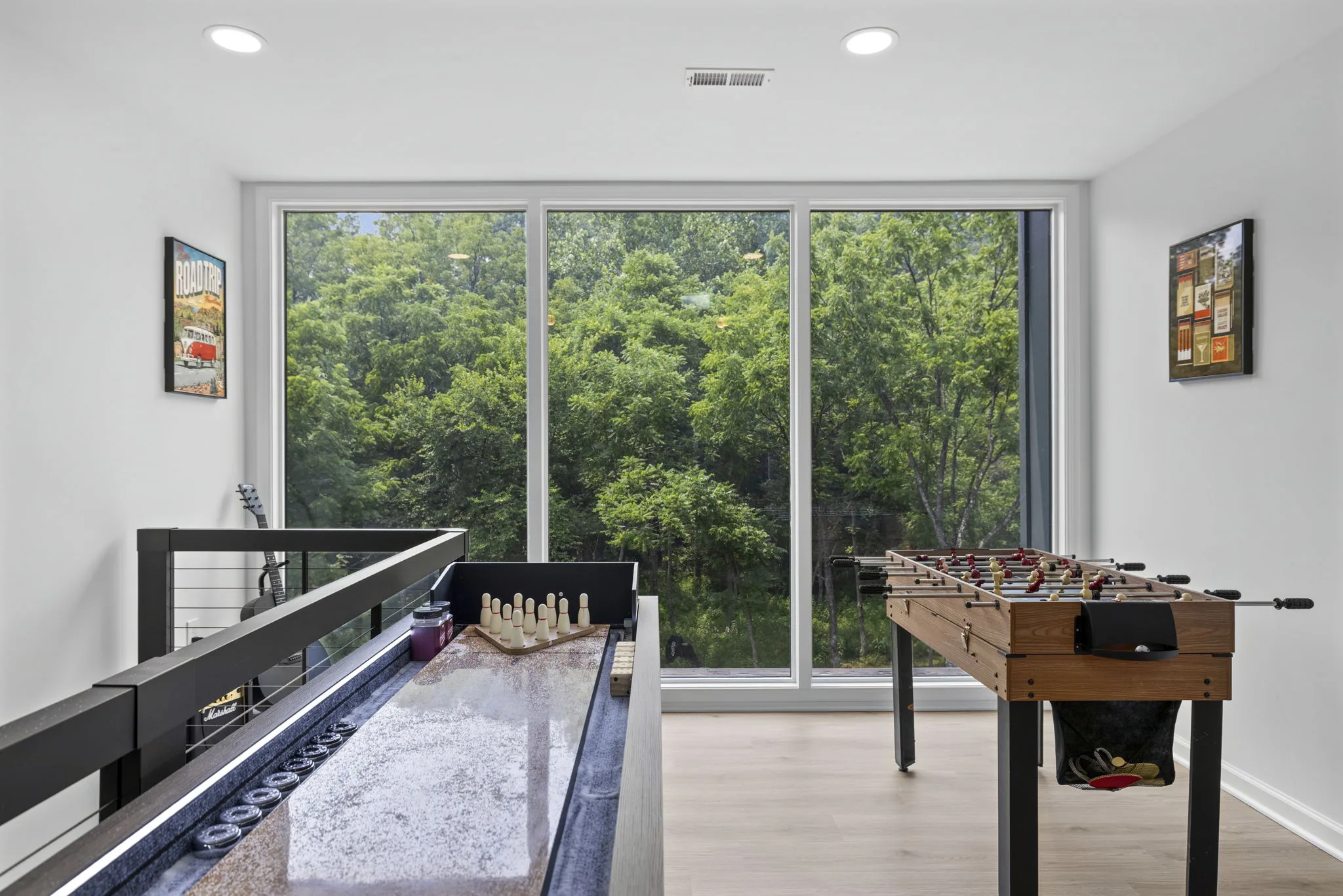 Game room with shuffleboard, foosball, and floor-to-ceiling windows