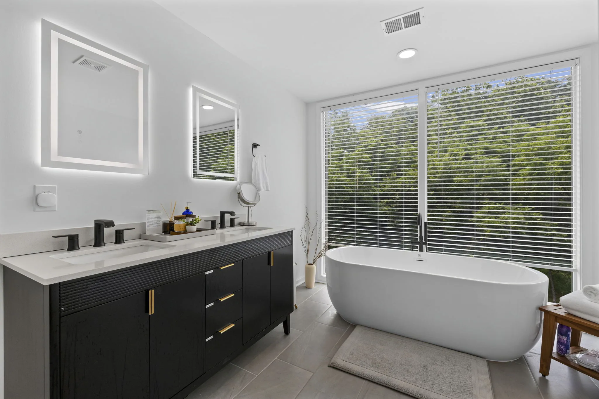 Modern bathroom with soaking tub and a view of the trees